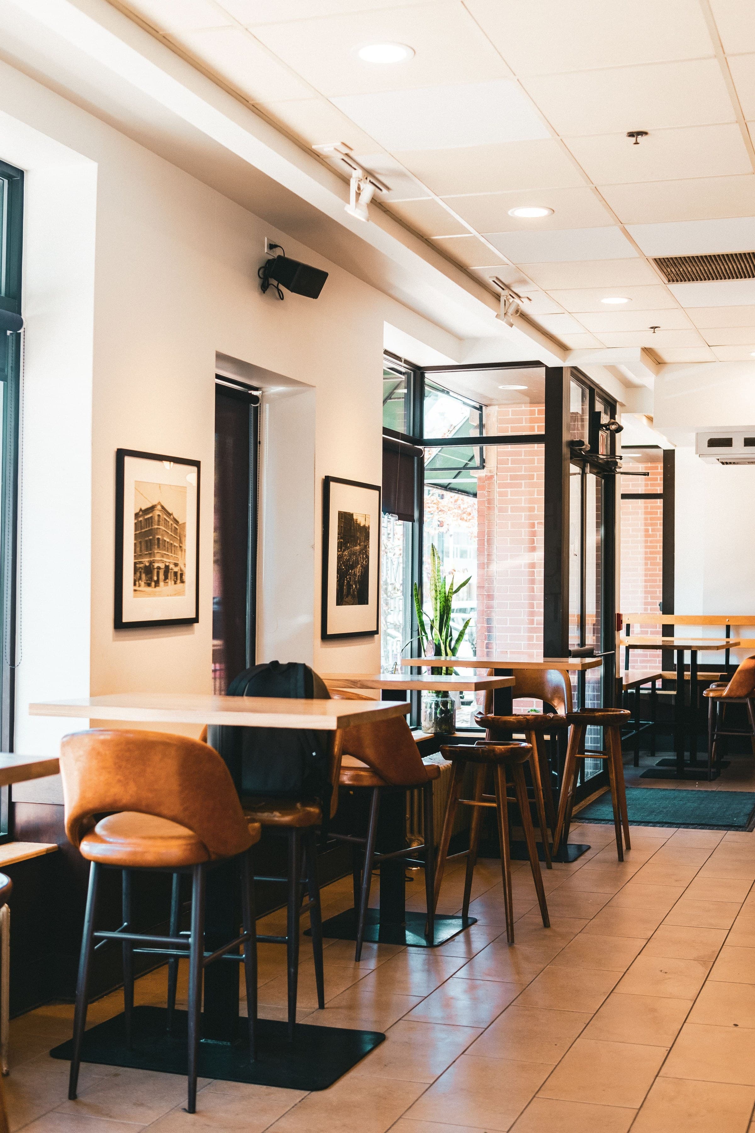 A finished commercial interior with exposed brick, custom seating, and framed artwork