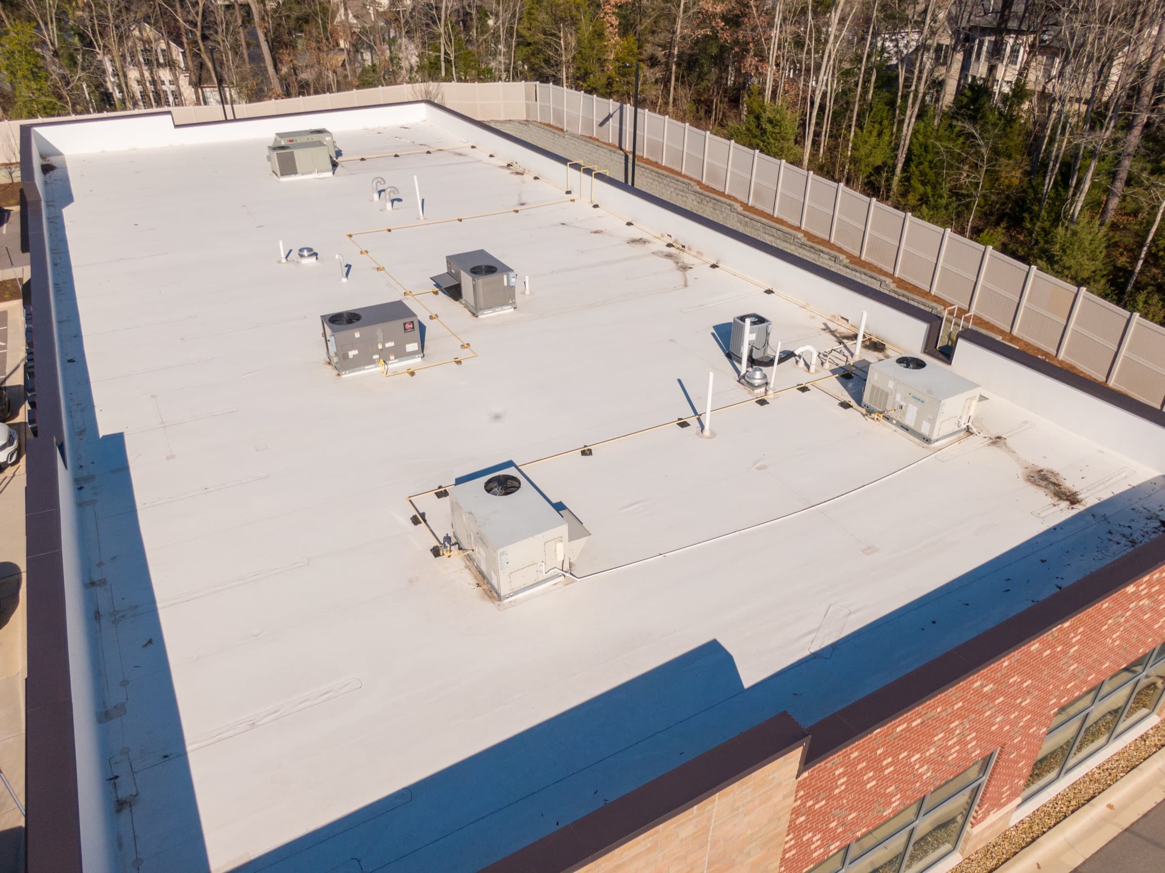 Aerial view of a white single-ply membrane roof on a commercial building