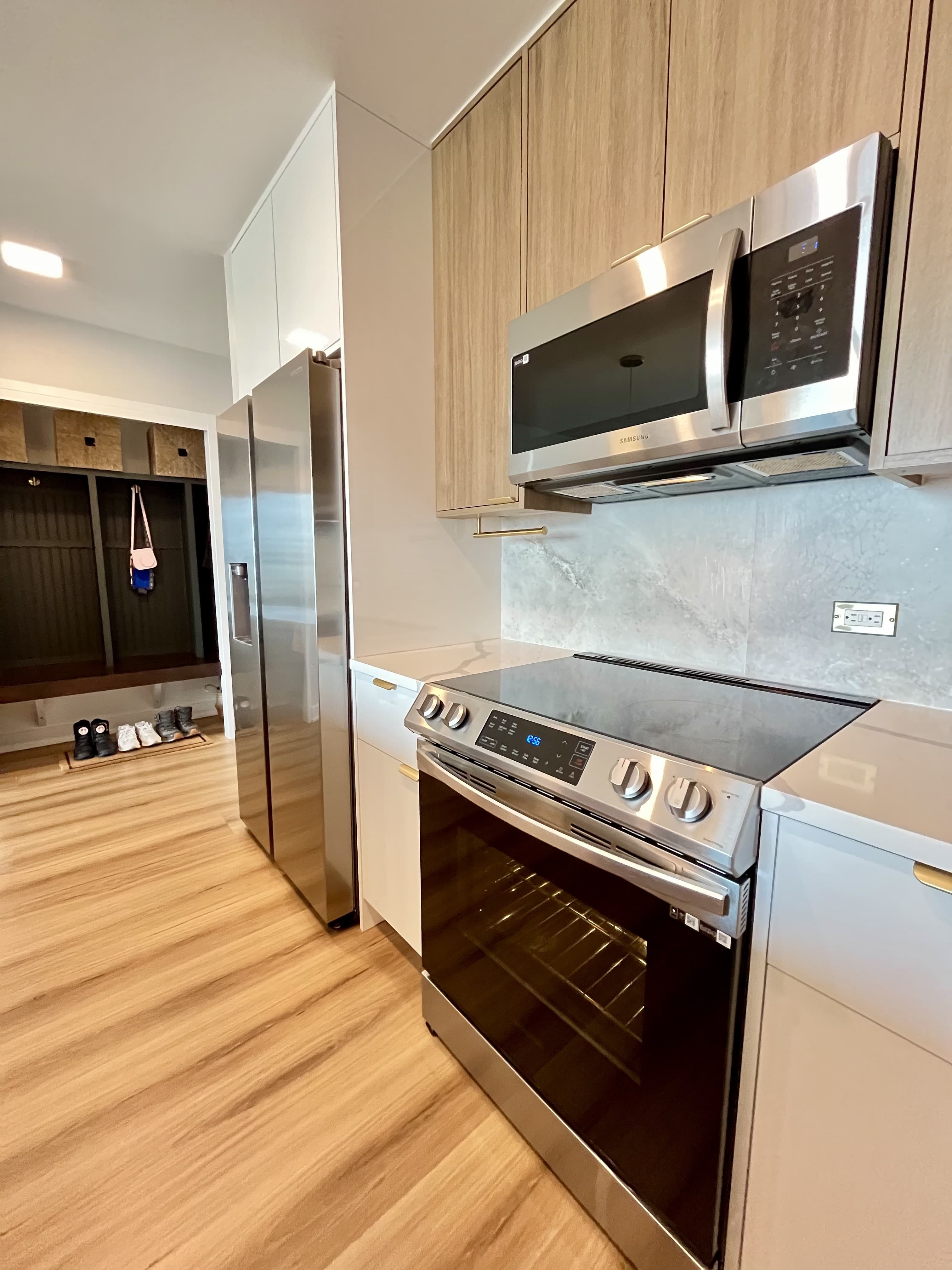 The renovated kitchen toward the refrigerator and hallway