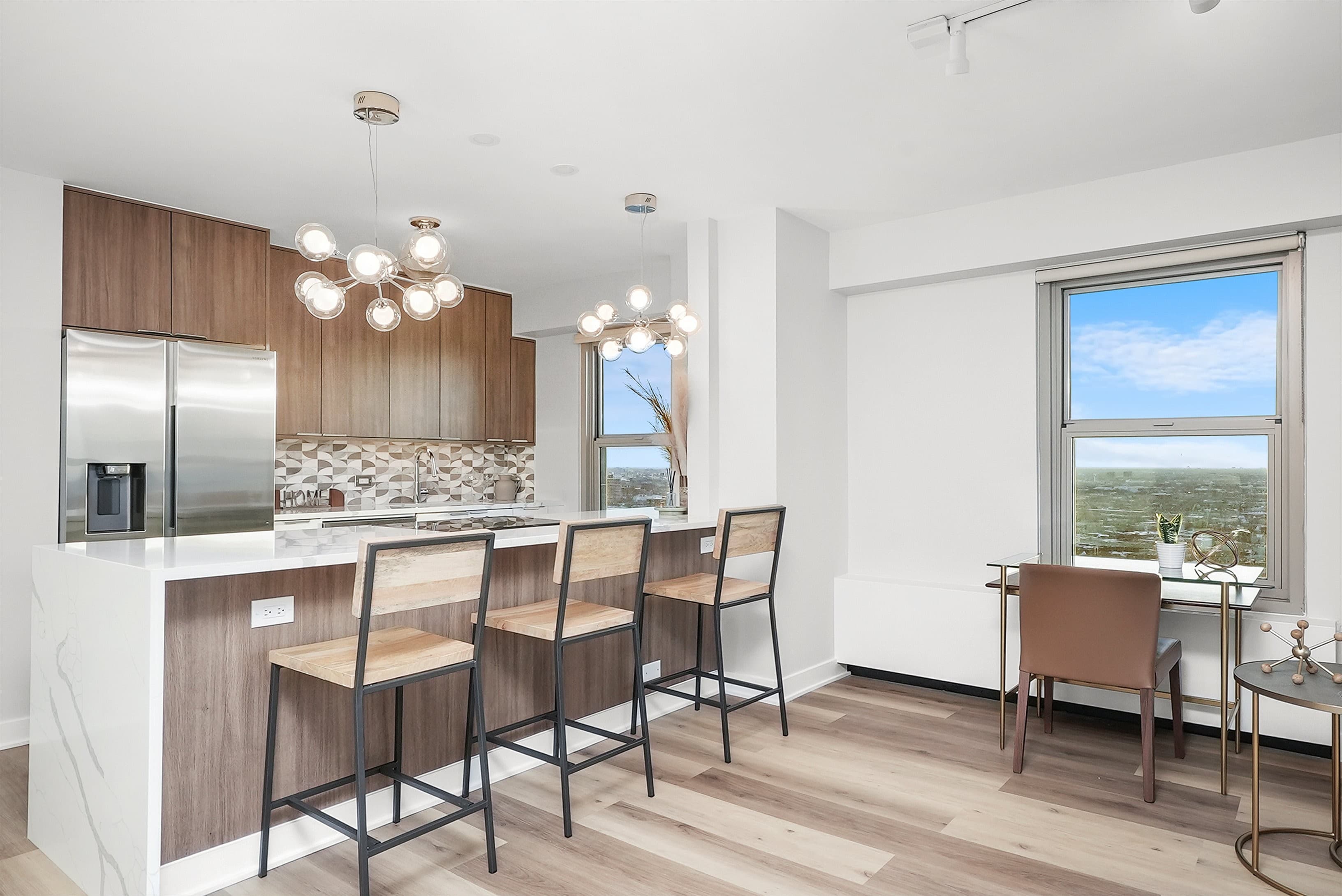 A renovated kitchen with a white quartz waterfall island