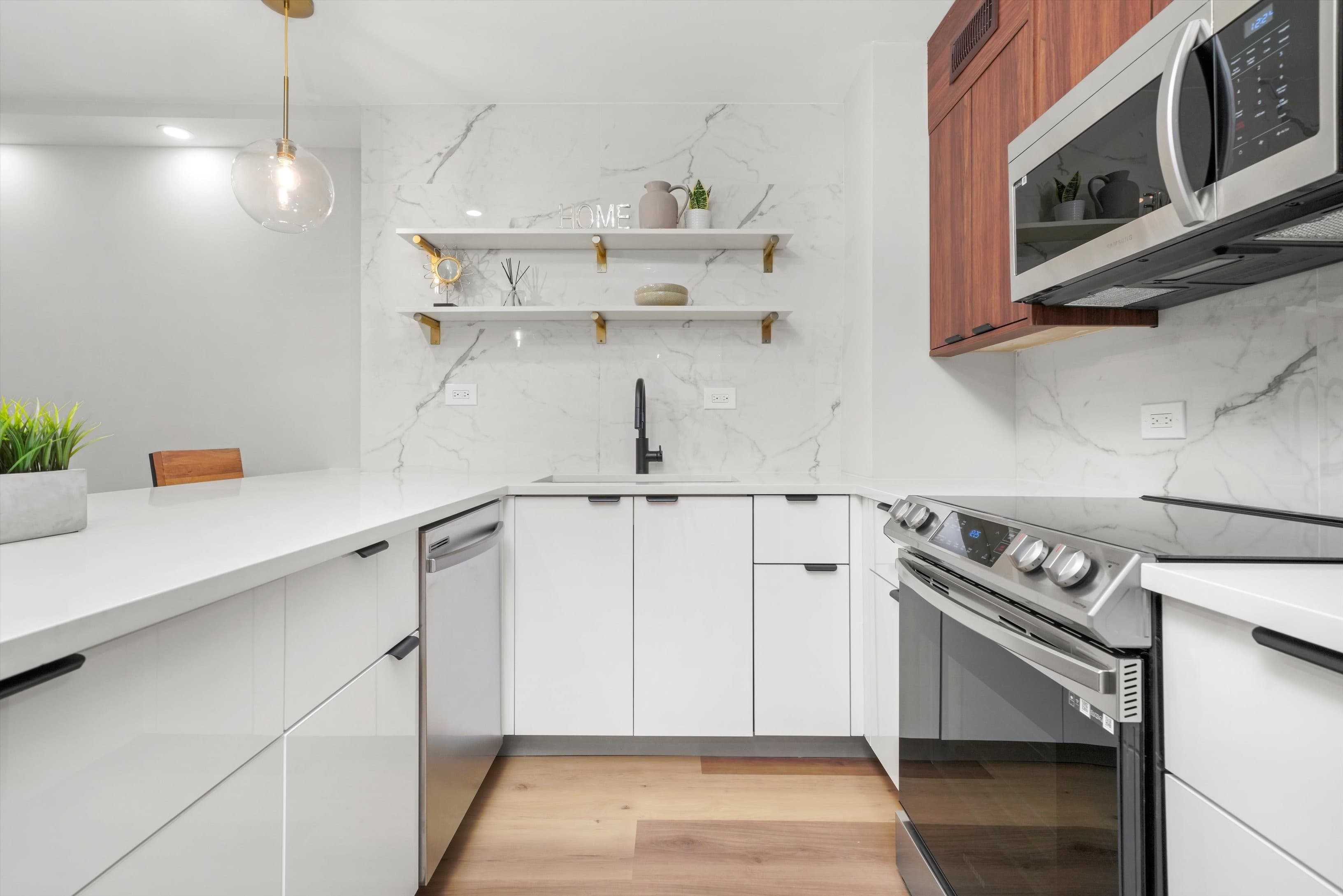 A close view of the marble backsplash with styled floating shelves