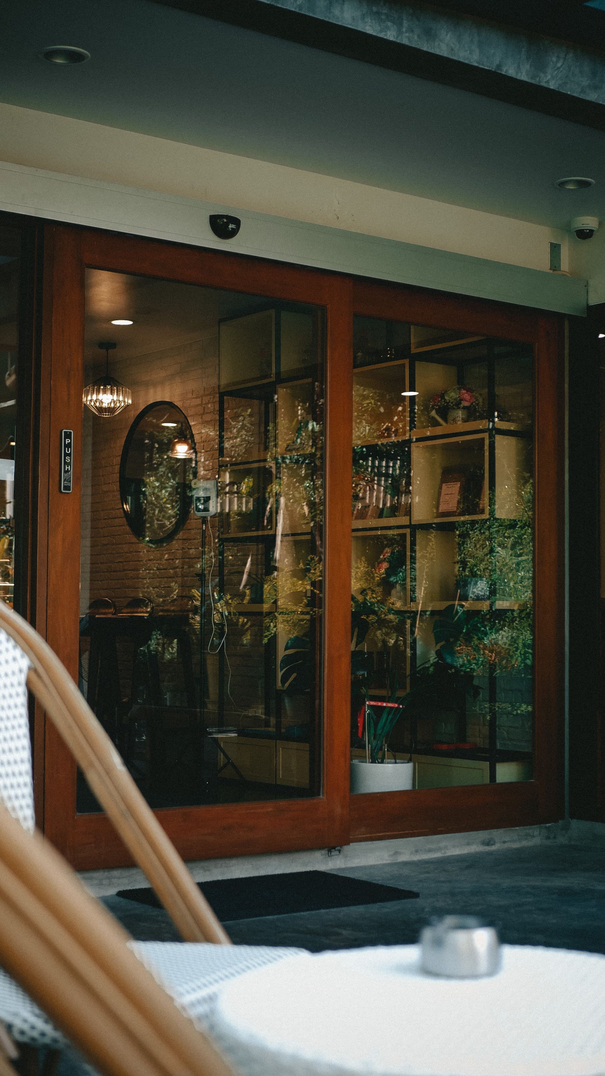 A wood-framed sliding glass storefront entry