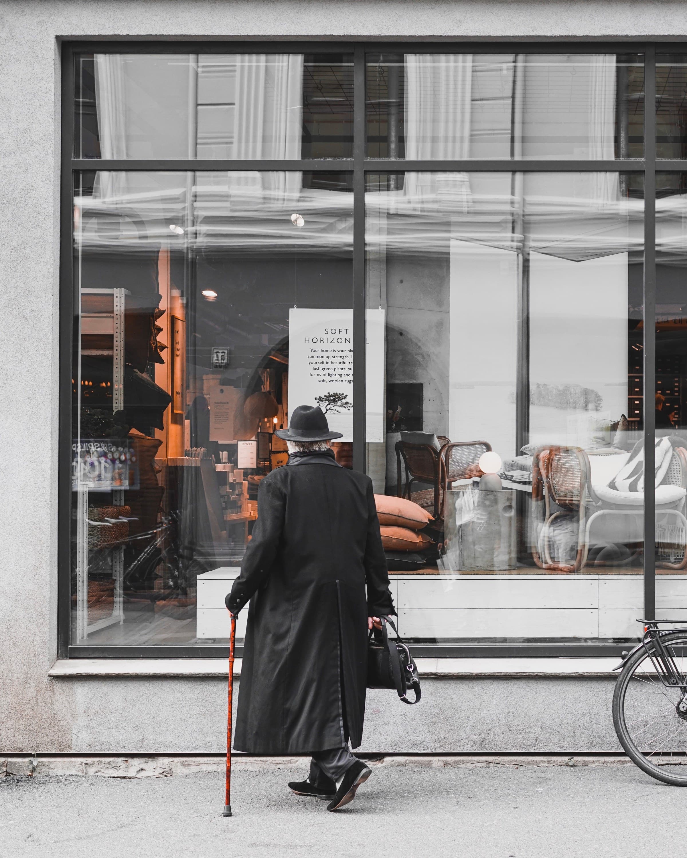 A commercial storefront window display with black-framed glass